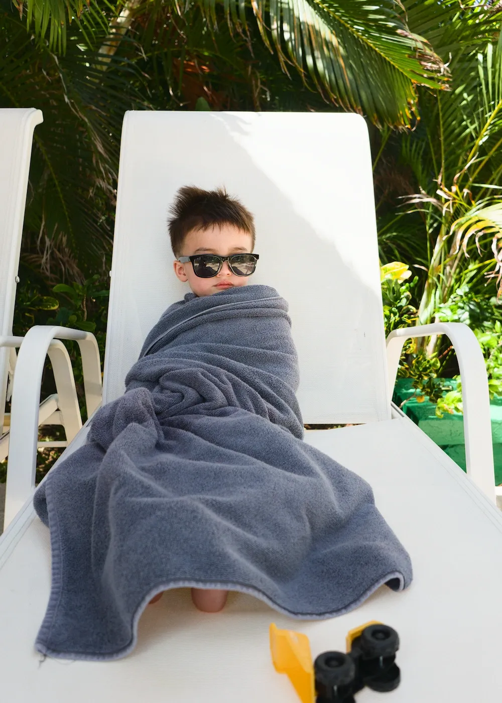 After another session in the hotel pool, Norris gets wrapped in a towel and waits for his french fries and ketchup to arrive. Two years old and already living his best Cancun resort life.